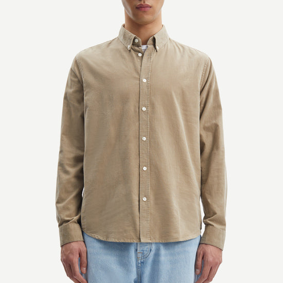 light brown baby cord button down shirt with single button cuff and curved hem model shot