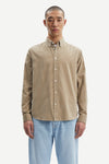 light brown baby cord button down shirt with single button cuff and curved hem model shot