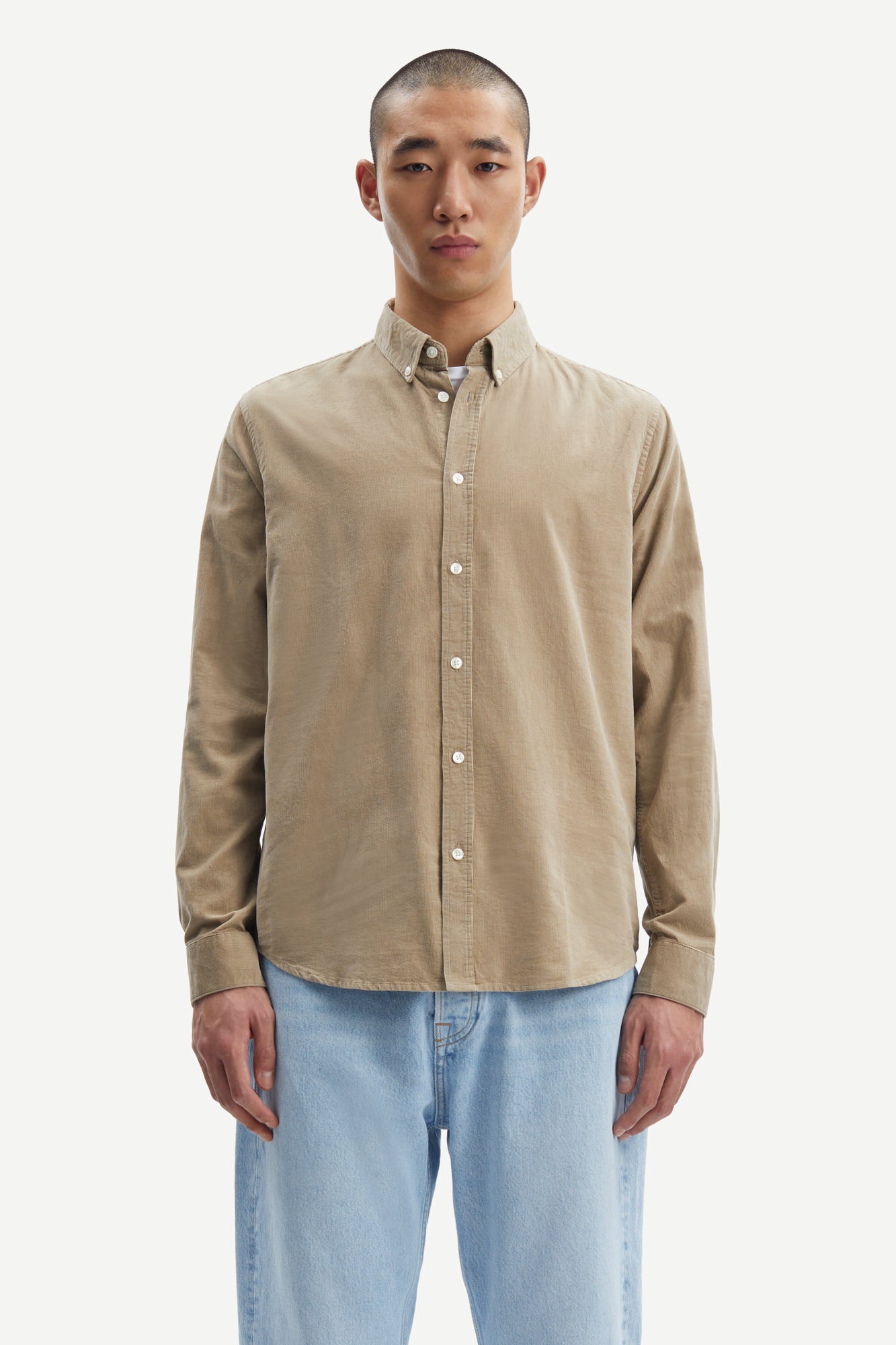 light brown baby cord button down shirt with single button cuff and curved hem model shot