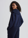 Rear view of navy half zip on model