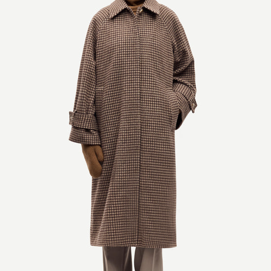 oversized brown check winter coat with wide sleeves with belted cuffs and concealed placket model shot