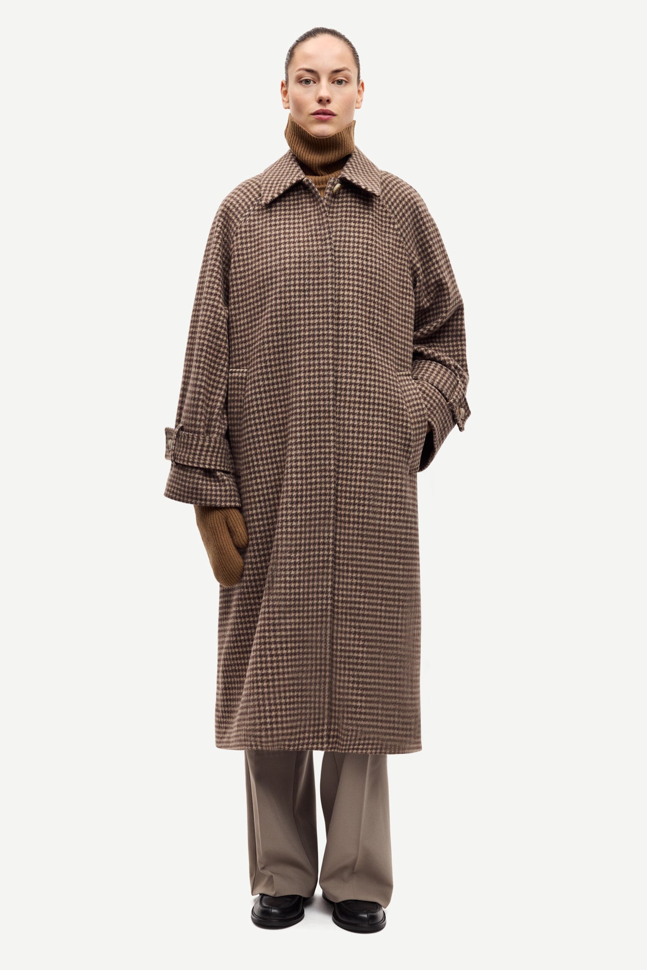 oversized brown check winter coat with wide sleeves with belted cuffs and concealed placket model shot