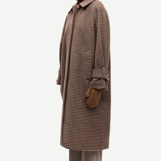 oversized brown check winter coat with wide sleeves with belted cuffs and concealed placket  side view 