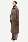 oversized brown check winter coat with wide sleeves with belted cuffs and concealed placket  side view 