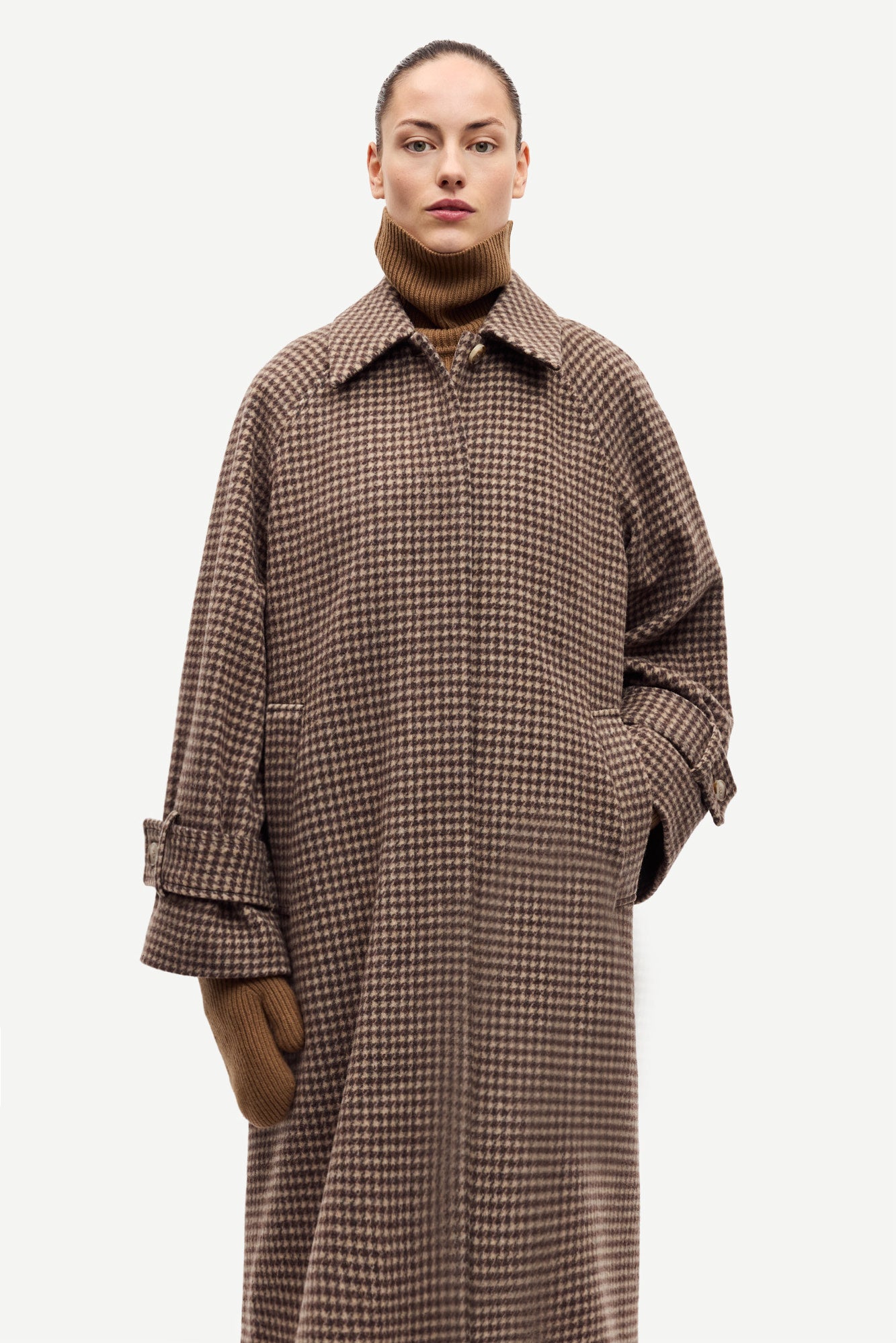 oversized brown check winter coat with wide sleeves with belted cuffs and concealed placket  model shot