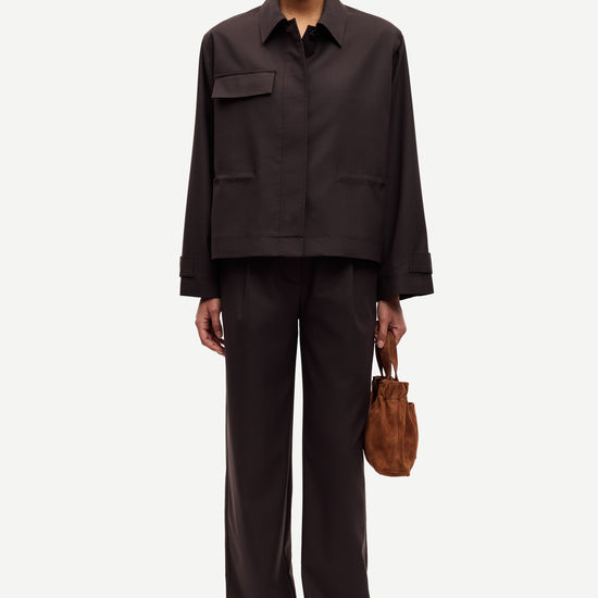 brown tailored trousers with pleated front, concealed fastening and straight fit model shot