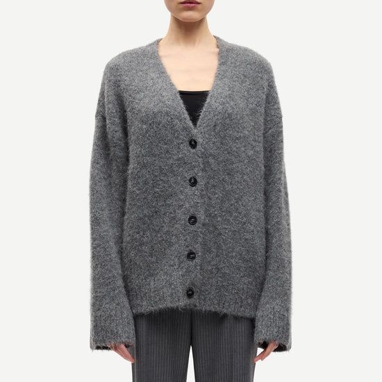 long sleeve grey wool cardigan with dark grey buttons and rib detailing model shot