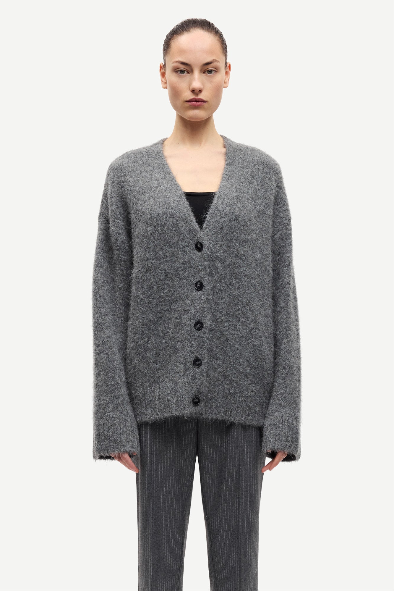long sleeve grey wool cardigan with dark grey buttons and rib detailing model shot