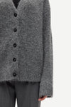 long sleeve grey wool cardigan with dark grey buttons and rib detailing close up