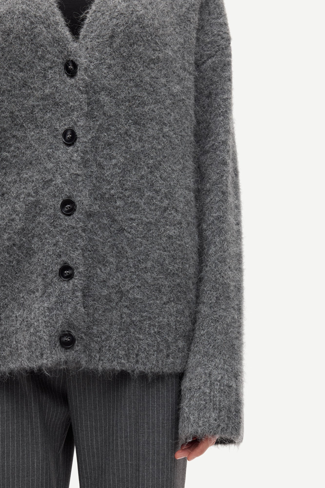long sleeve grey wool cardigan with dark grey buttons and rib detailing close up