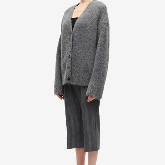 long sleeve grey wool cardigan with dark grey buttons and rib detailing side view 