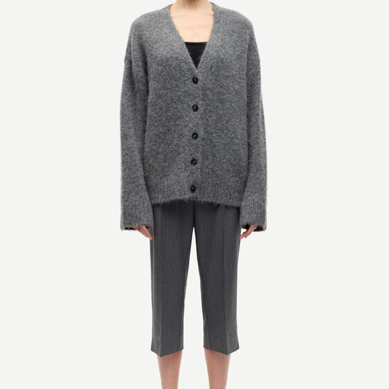 long sleeve grey wool cardigan with dark grey buttons and rib detailing model shot