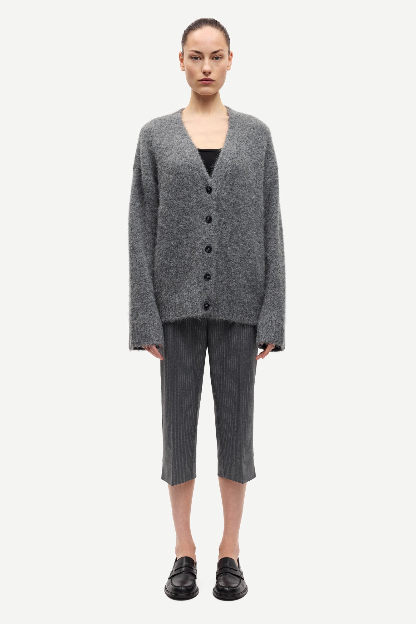 long sleeve grey wool cardigan with dark grey buttons and rib detailing model shot