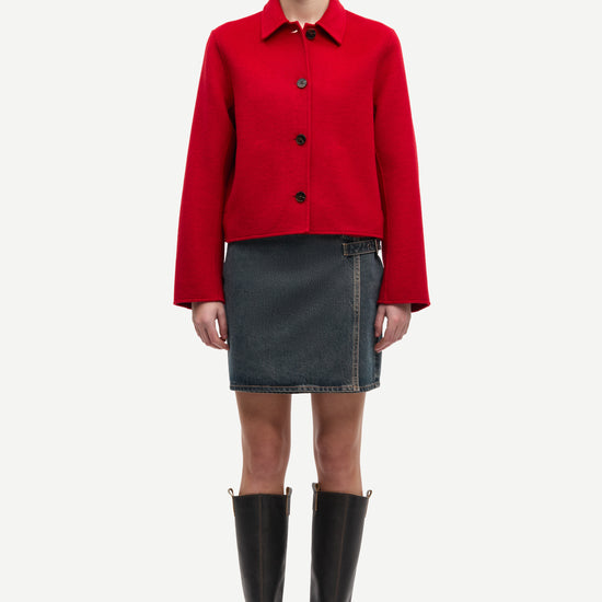 red boxy wool jacket with classic collar, black buttons and slightly cropped fit model shot