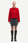 red boxy wool jacket with classic collar, black buttons and slightly cropped fit model shot