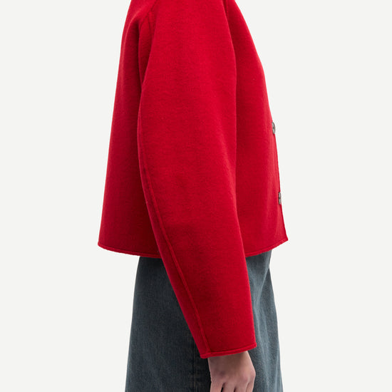 red boxy wool jacket with classic collar, black buttons and slightly cropped fit side view 