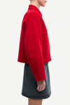 red boxy wool jacket with classic collar, black buttons and slightly cropped fit side view 