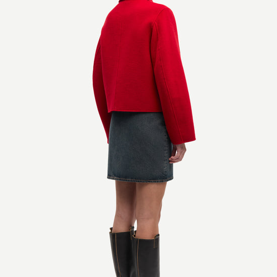 red boxy wool jacket with classic collar, black buttons and slightly cropped fit rear view 