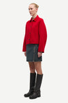 red boxy wool jacket with classic collar, black buttons and slightly cropped fit side view 