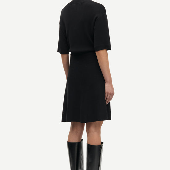 black short dress with flutter sleeves and waterfall skirt rear view 