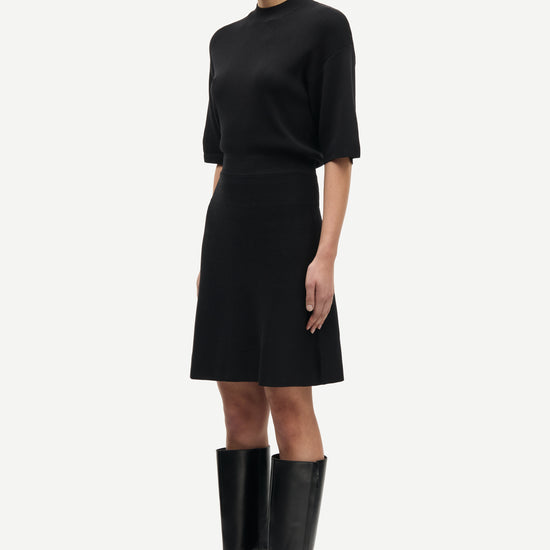 black short dress with flutter sleeves and waterfall skirt side view 