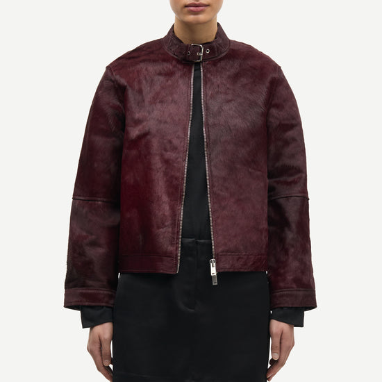 brown leather jacket with buckle at the neck and boxy fit model shot