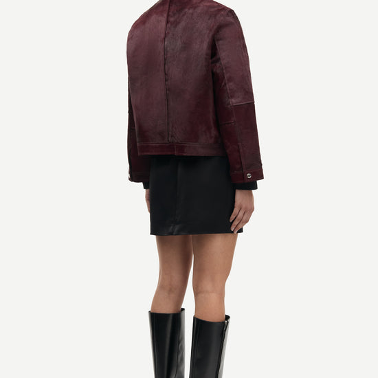 brown leather jacket with buckle at the neck and boxy fit rear view