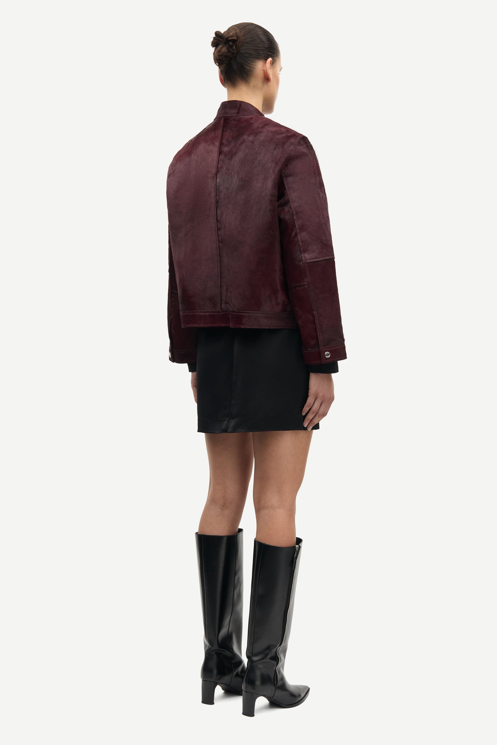 brown leather jacket with buckle at the neck and boxy fit rear view