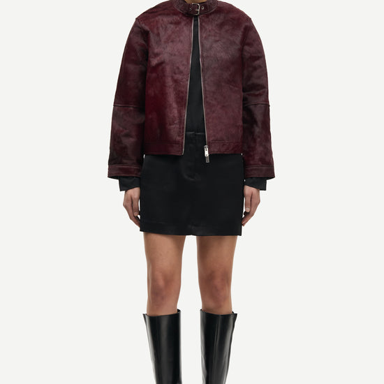 brown leather jacket with buckle at the neck and boxy fit model shot