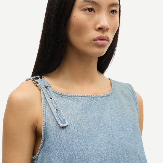 blue cotton tank top with belt detail on one shoulder and cut in a denim style close up