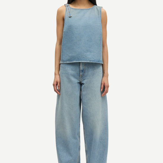 blue cotton tank top with belt detail on one shoulder and cut in a denim style model shot