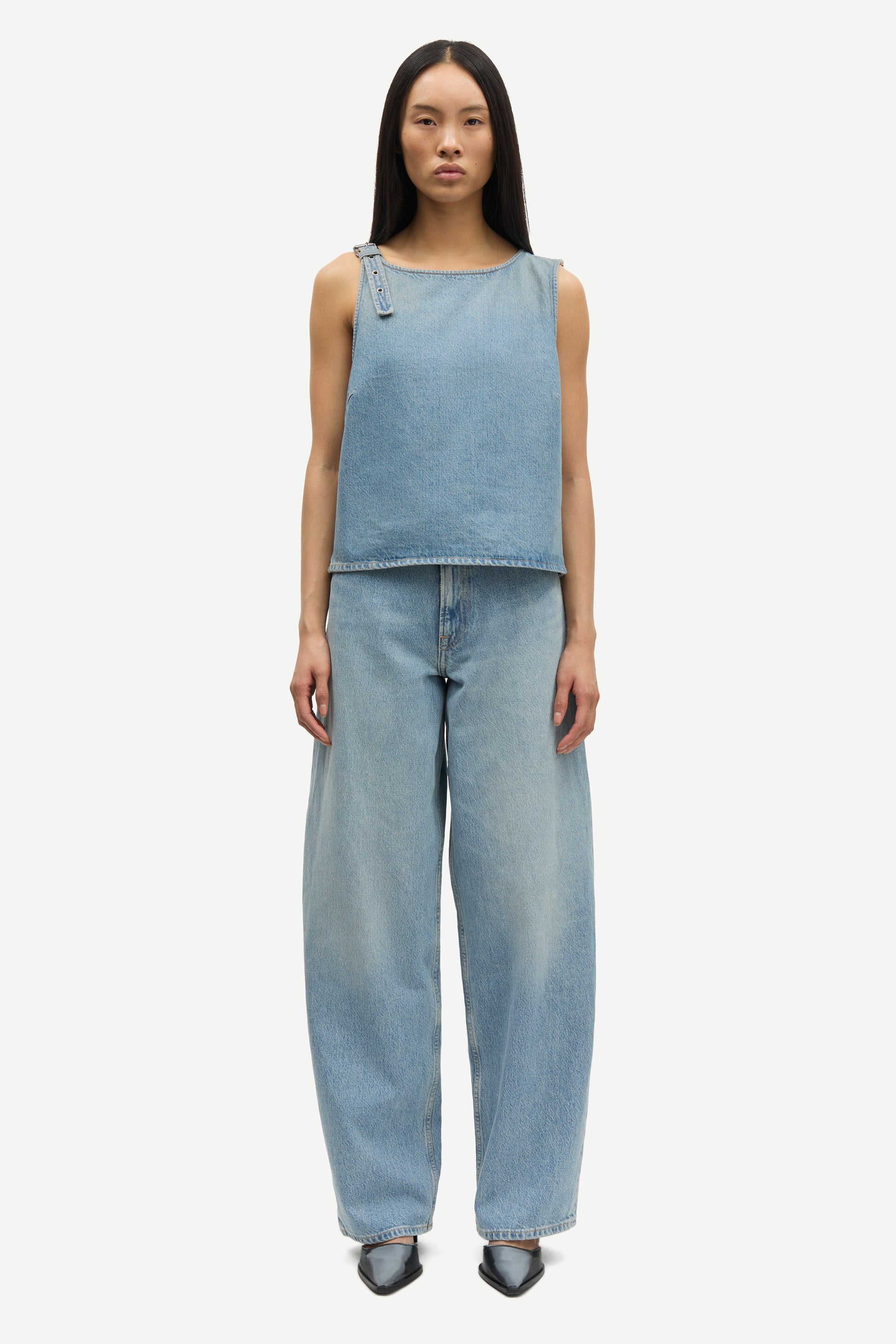 blue cotton tank top with belt detail on one shoulder and cut in a denim style model shot