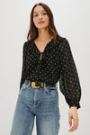 V neck black top with ruffled neck and polka dots model shot