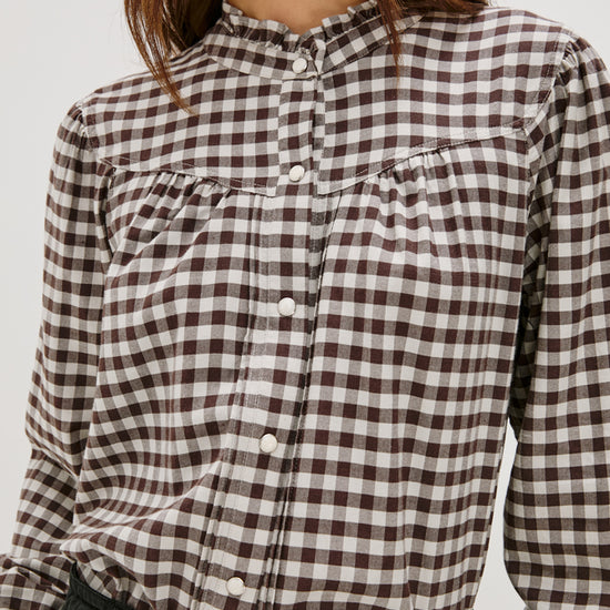 round neck top with chocolate brown check print and white buttons close up