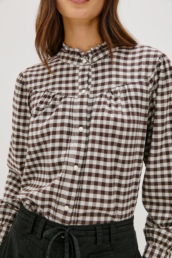 round neck top with chocolate brown check print and white buttons close up