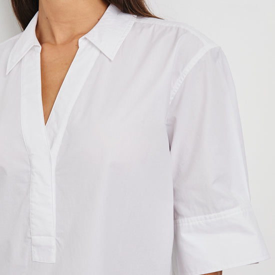 White short sleeve top with v neck, collar and boxy fit close up