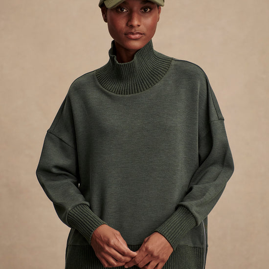 Olive green jumper with rib detailing and side zip model shot