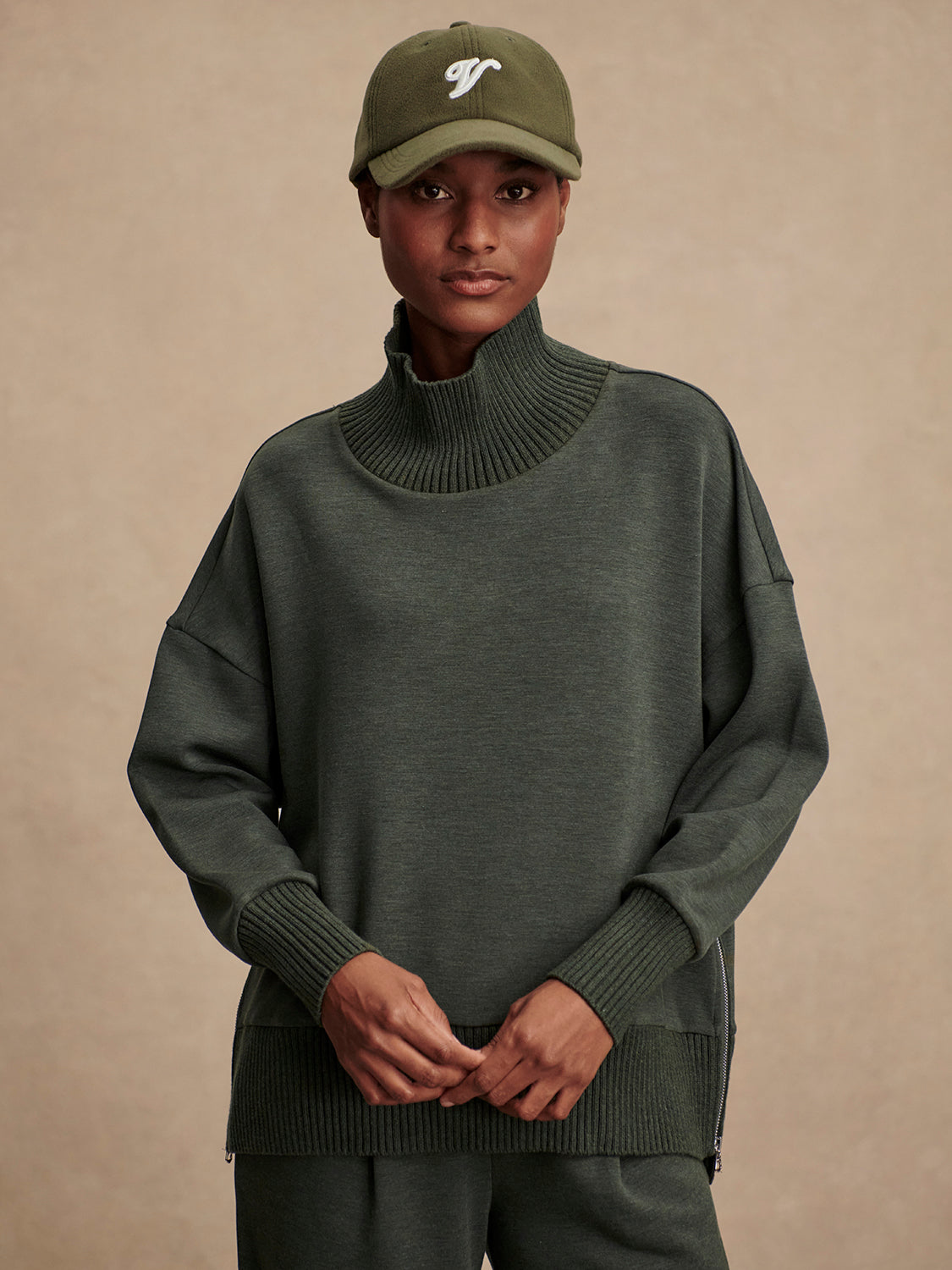 Olive green jumper with rib detailing and side zip model shot
