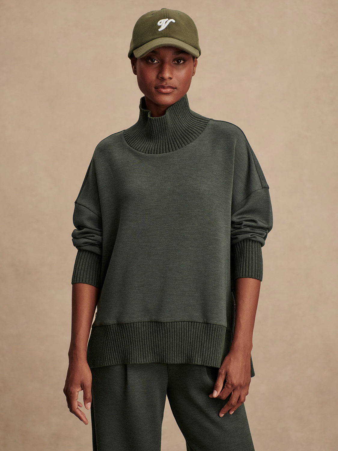 Olive green jumper with rib detailing and side zip