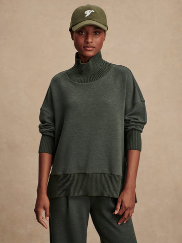 Olive green jumper with rib detailing and side zip