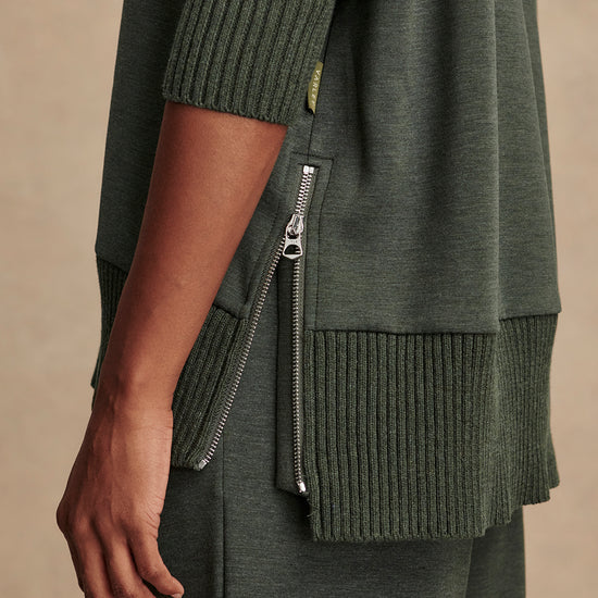 Olive green jumper with rib detailing and side zip close up