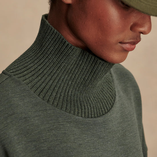 Olive green jumper with rib detailing and side zip close up