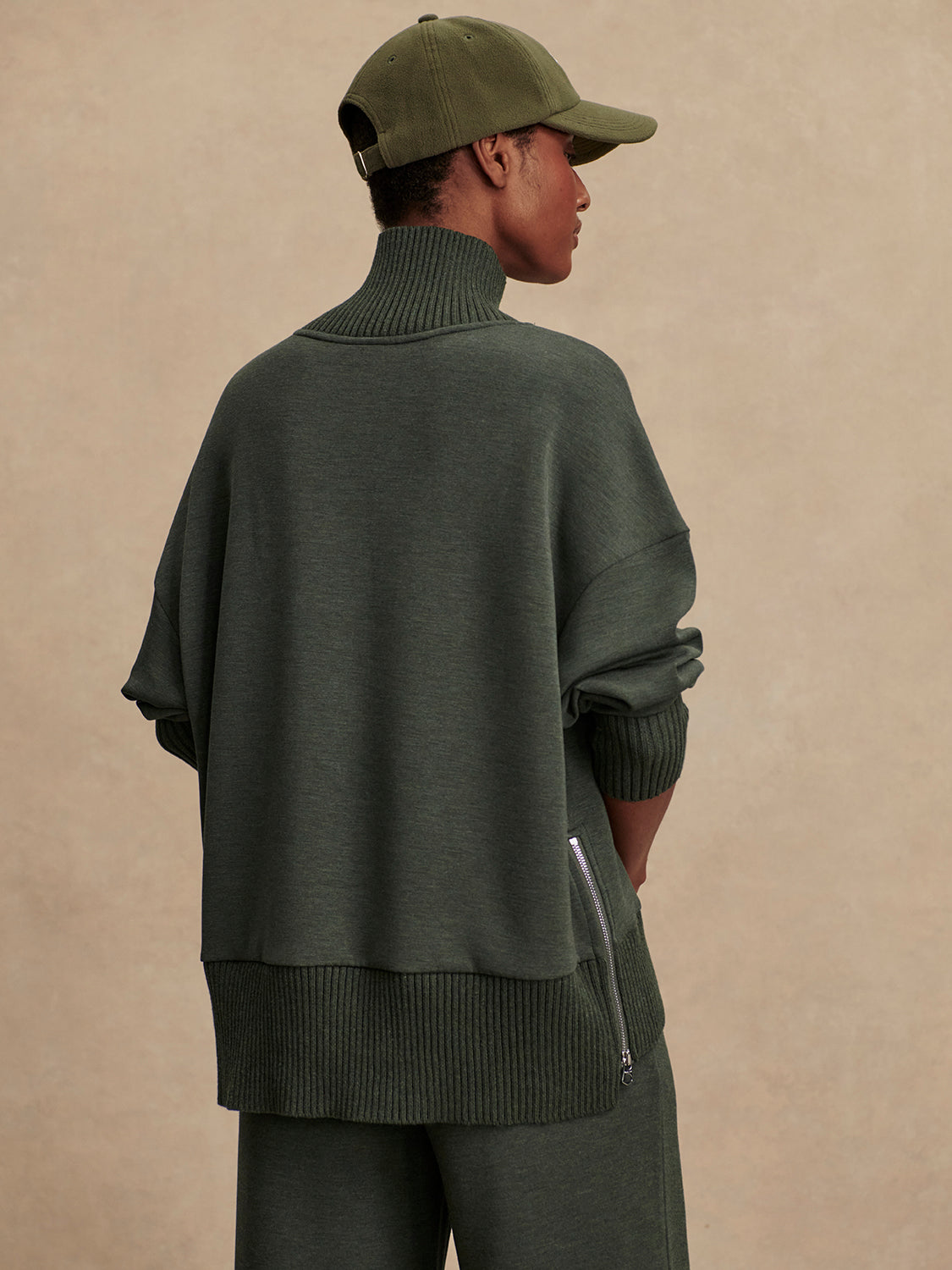 Olive green jumper with rib detailing and side zip rear view