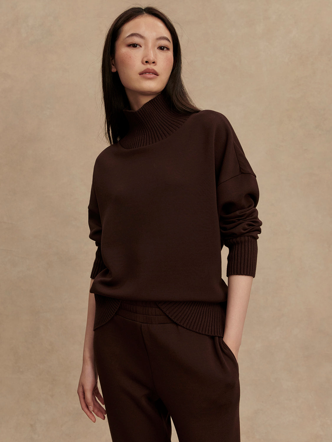 brown jumper with rib detailing and side zip model shot from Varley