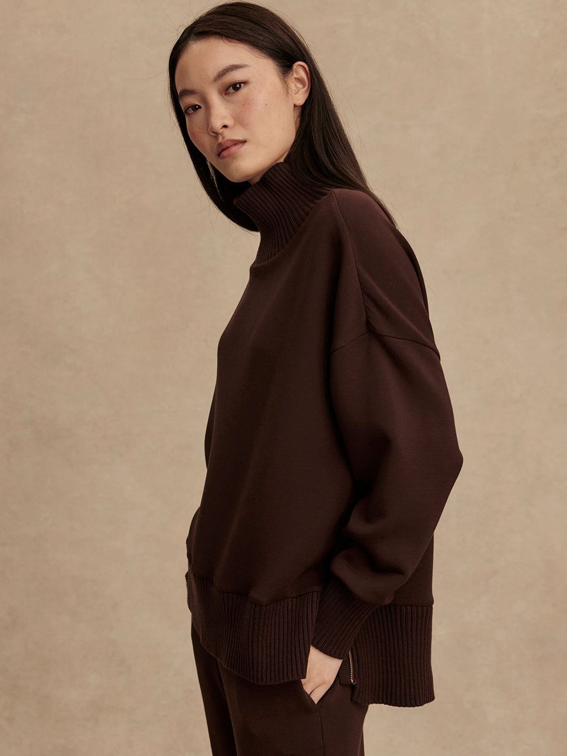 brown jumper with rib detailing and side zip side view from Varley