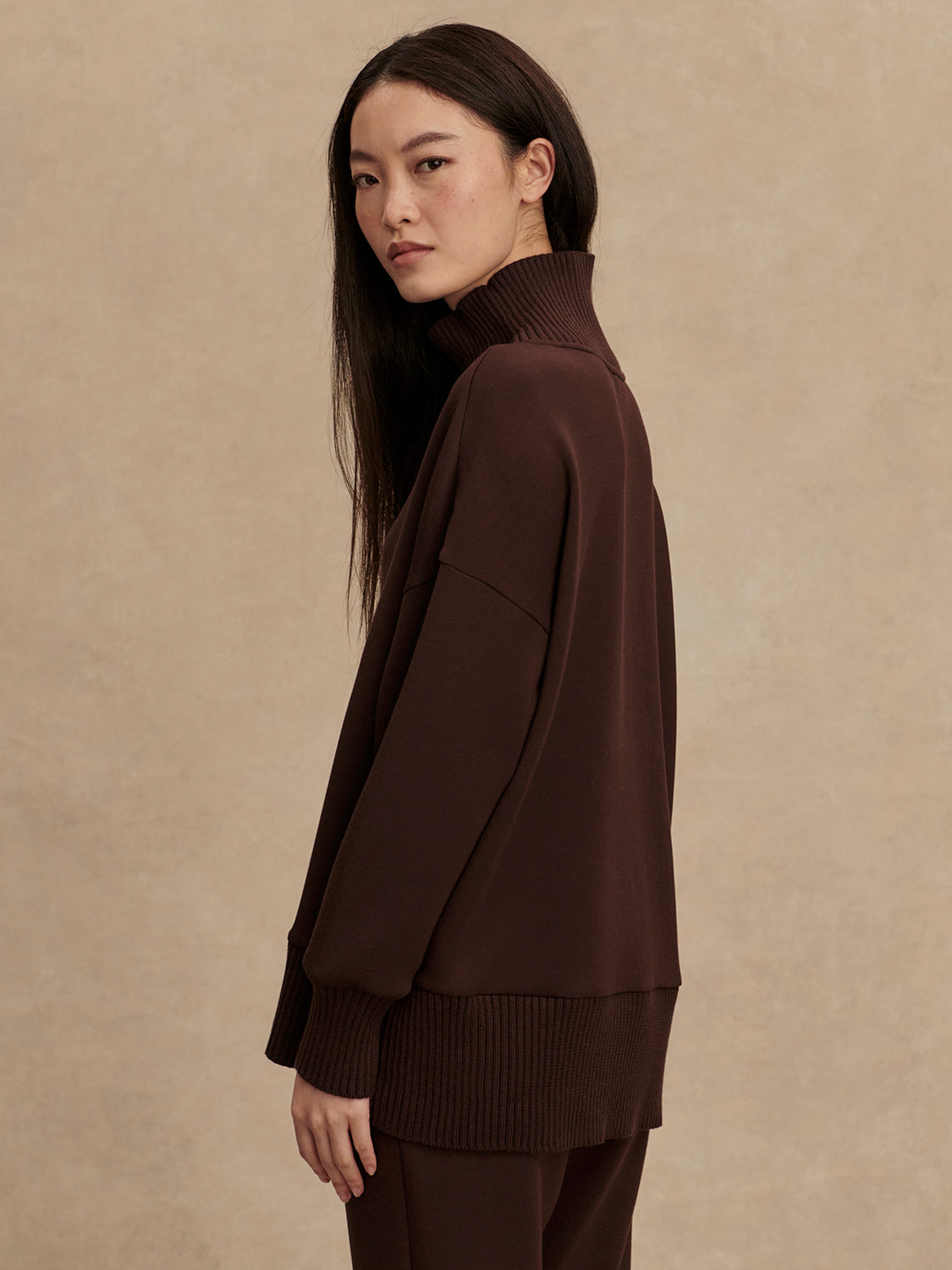 brown jumper with rib detailing and side zip side view from Varley