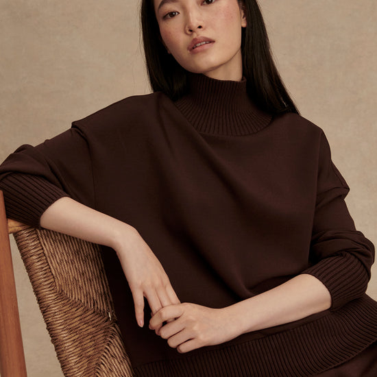 brown jumper with rib detailing and side zip model shot from Varley