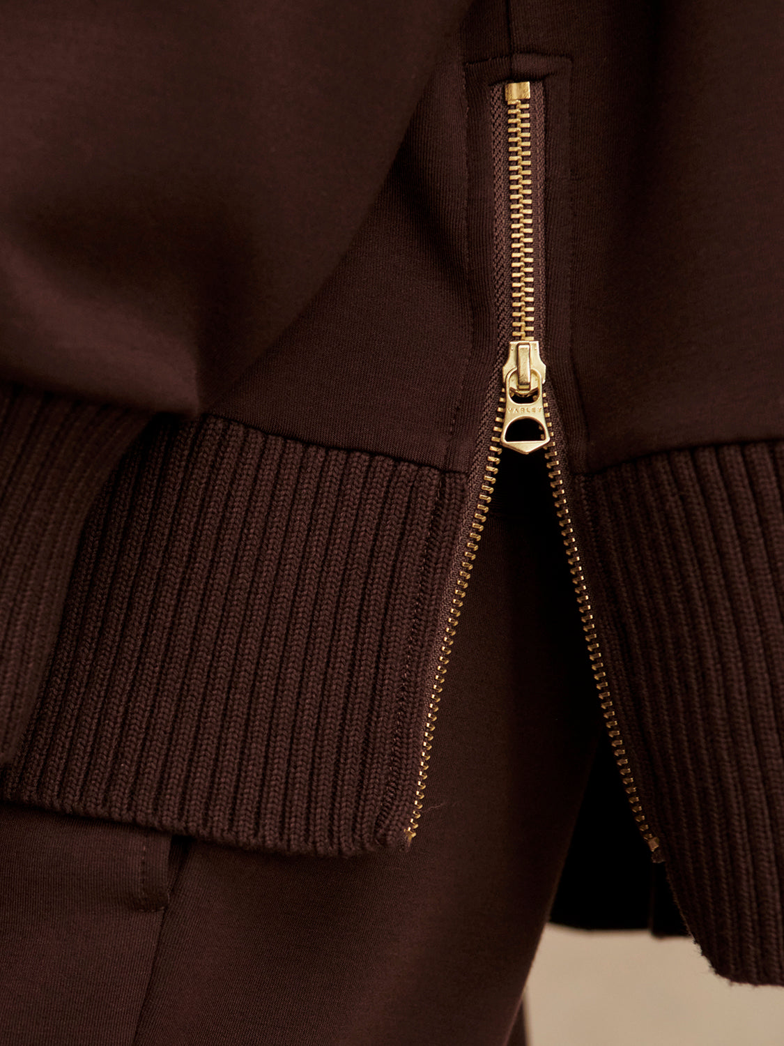 brown jumper with rib detailing and side zip close up of zip from Varley