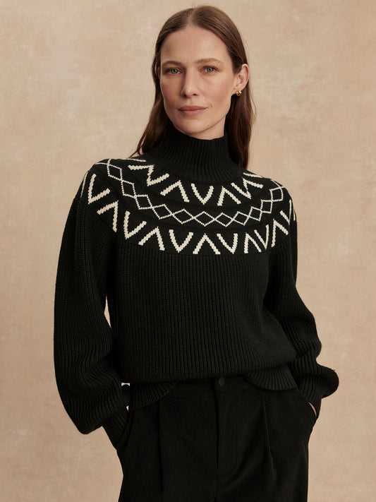 black ribbed jumper with high neck, white varley detailing around the neckline