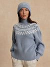 blue ribbed jumper with white varley logo and high neck